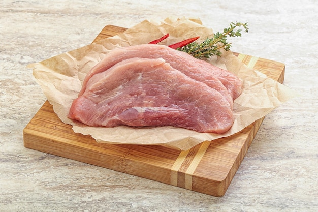 Raw pork schnitzel cut for roast