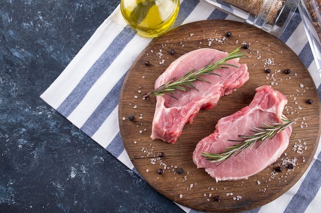 Raw pork steaks with rosemary and olive oil