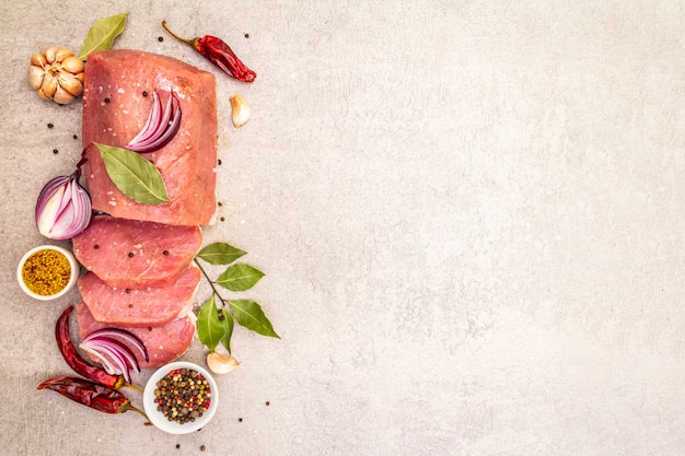 Raw pork tenderloin with vegetables and spices