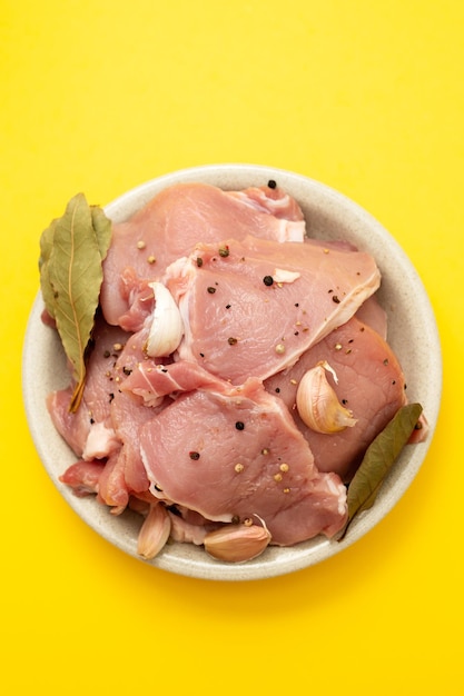 Raw pork with black pepper garlic and bay leaf on dish