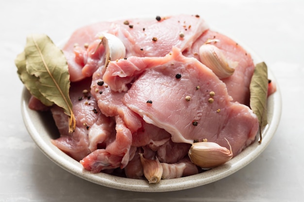 Raw pork with black pepper garlic and bay leaf on dish