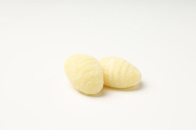 Raw potato gnocchi on white background close up