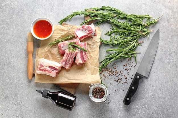 Raw ribs with spices on kitchen table