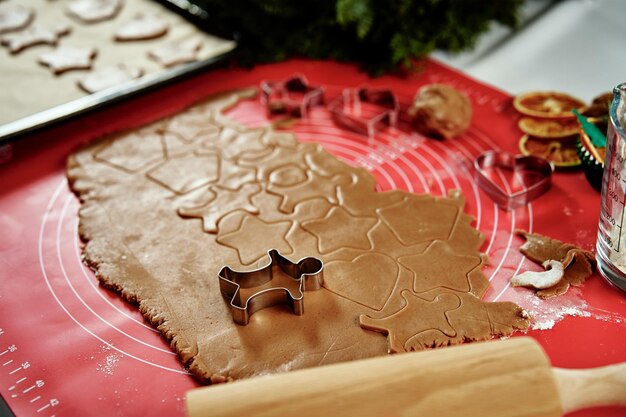 Raw rolled dough for ginger cookies with cutter in shape of man traditional sweets for winter holida