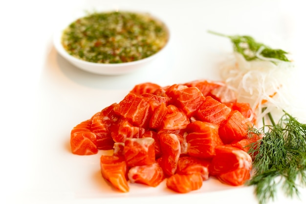 Raw salmon slice or salmon sashimi in Japanese style fresh serve with sauce