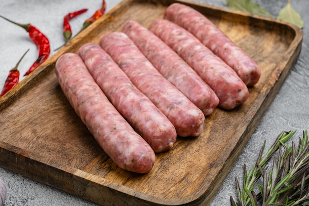 Raw Sausages with Herbs and Spices set, on gray stone table background