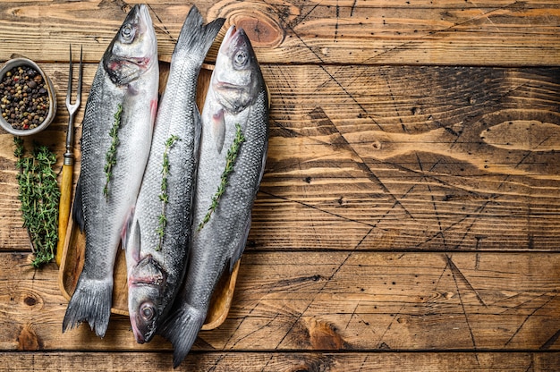 Raw seabass fish on a tray.