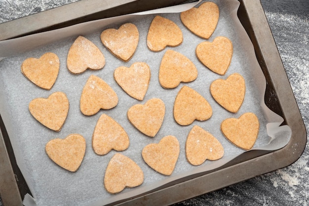 Raw shortbread cookies on baking sheet Cookies making process Top view