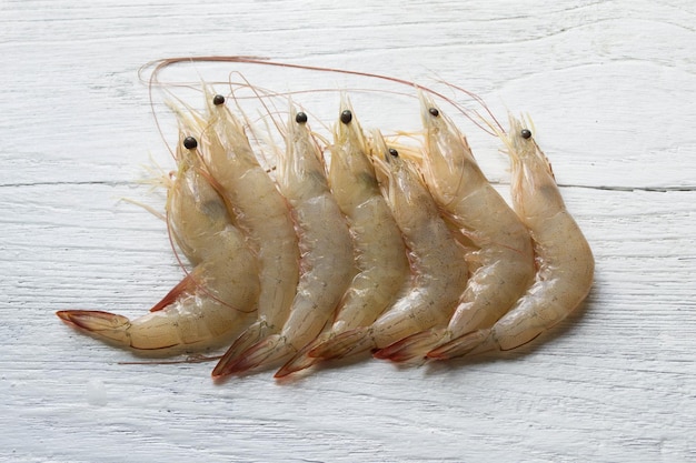 Raw shrimp on white wooden