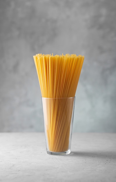 Raw spaghetti in a glass. Dry italian pasta prepared from durum wheat