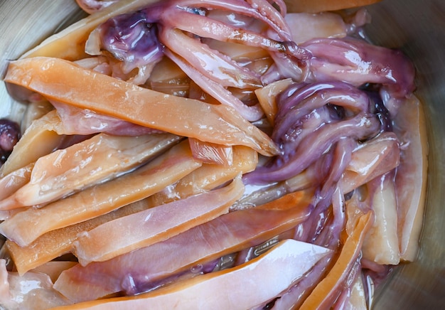 Raw squid for cooking food on wooden table preserving food seafood pickled squid on bowl