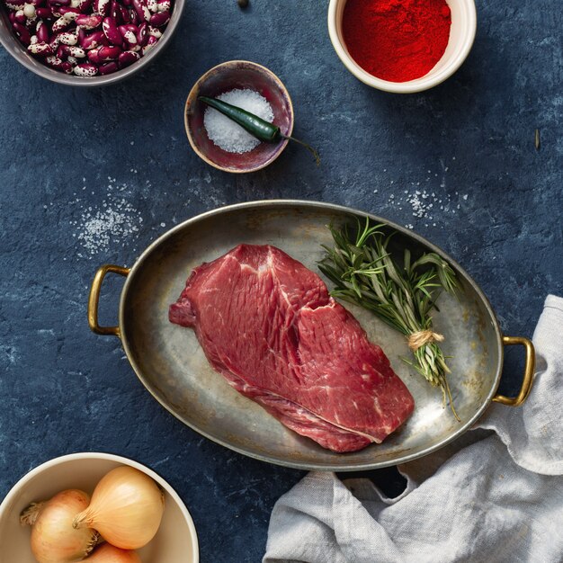 Raw steak with ingredients for cooking healthy food top view