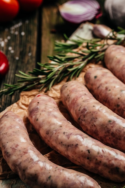 Raw stuffed sausages in cookware on a wooden background Sausages for grilling vertical image top view place for text