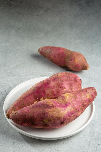 Raw sweet potato on the table