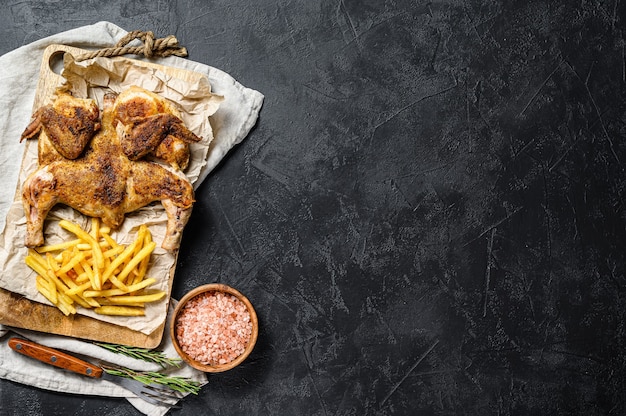 Raw tabaka chicken on wooden board