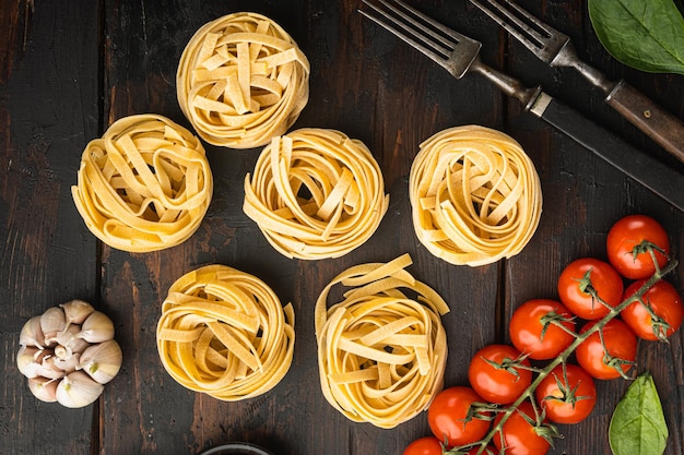 Raw tagliatelle nests Traditional Italian pasta set, top view flat lay