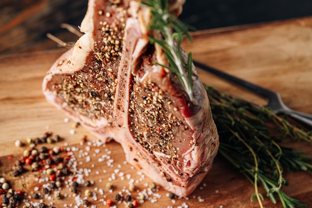 Raw tbone steak with spices ready for frying