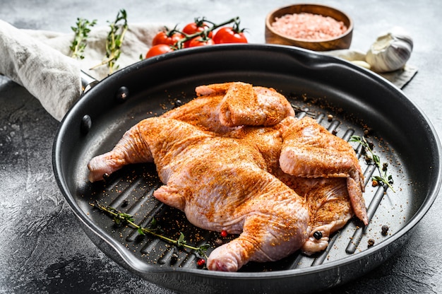 Raw tobacco chicken in pan. Top view