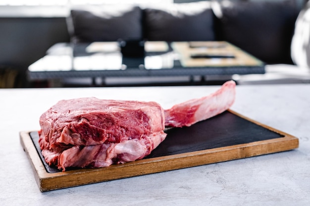 Raw tomahawk steak on tray