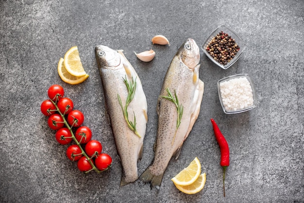 Raw trout fish on stone background