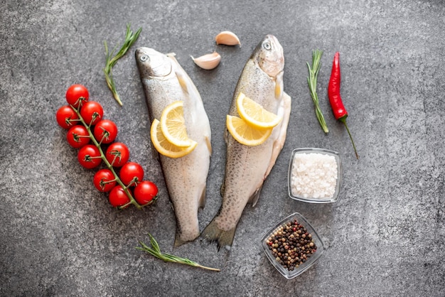 Raw trout fish on stone background