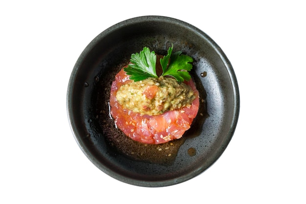 Raw tuna ceviche with sauce Appetizing traditional snack Top view Closeup Isolated on white background