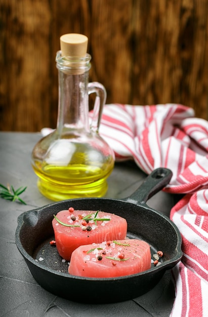 Raw Tuna fish steaks  in a cast iron pan