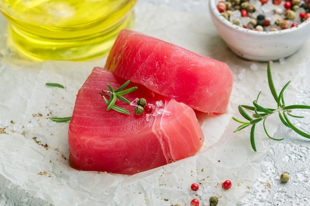 Raw Tuna fish steaks with sea salt pepper and rosemary