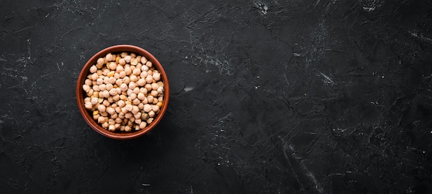 Raw Turkish Pea. Nut. On a black background. Top view. Free copy space.