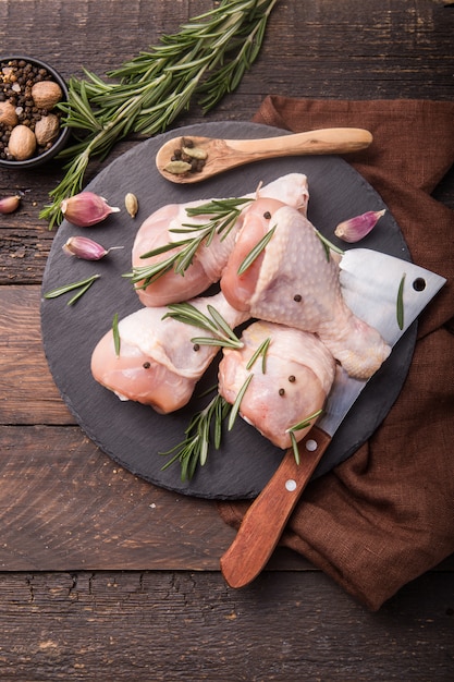 Raw uncooked chicken legs with herbs