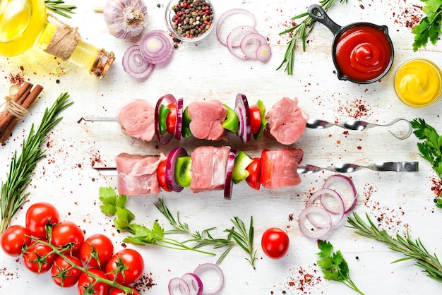 Raw veal kebab with rosemary and vegetables Top view Free space for your text