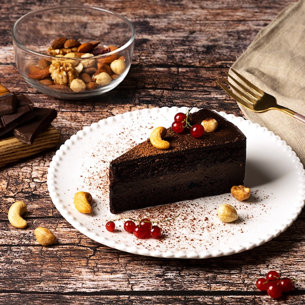 Raw vegan chocolate cake on dark vintage background