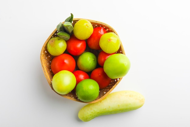 Raw vegetable in wooden bowl on white background