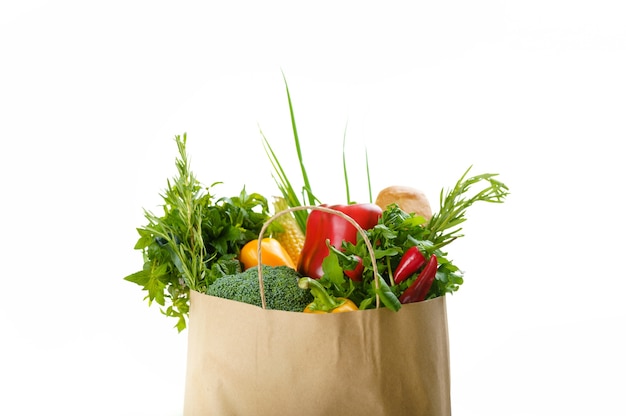 Raw vegetables and fruits in cotton bag, isolated. Organic vegetarian food, grocery products, healthy lifestyle concept