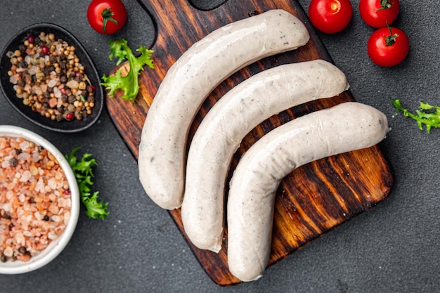 Photo raw white sausage weisswurst veal pork lard spices natural meal food snack on the table