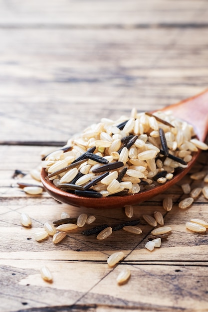 Raw wild rice in a wooden spoon