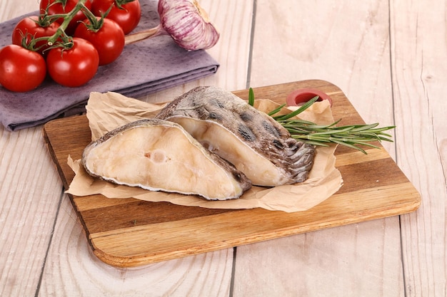 Raw wolffish steak for cooking served rosemary