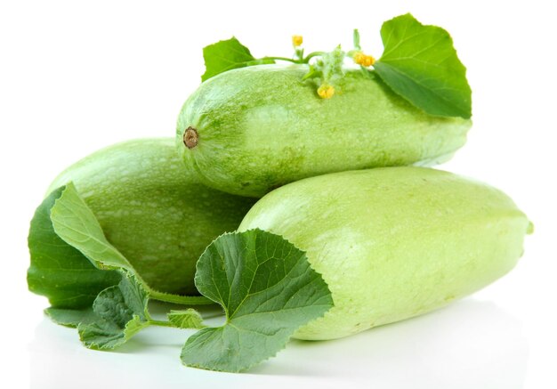 Raw zucchini with leaves isolated on white