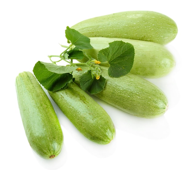 Raw zucchini with leaves isolated on white