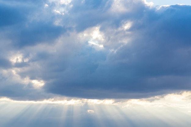 Rays of light shining through the rain cloudslight shining from heaven past the gray clouds