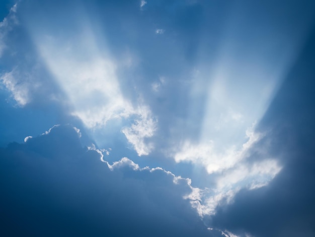 The rays of sunlight penetrate the clouds after rain.