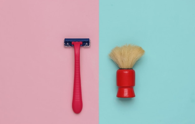 Razor shaving brush on a pastel pinkblue background