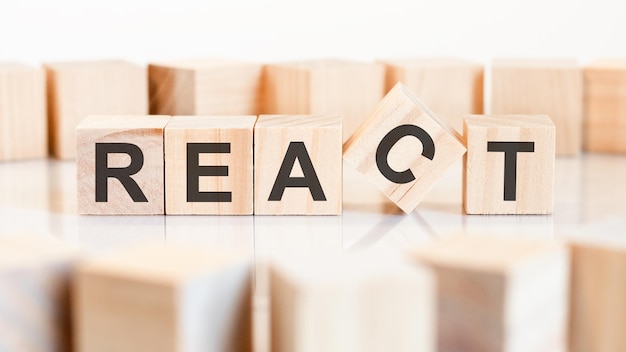 React - words from wooden blocks with letters, of inform brief concept, white background.