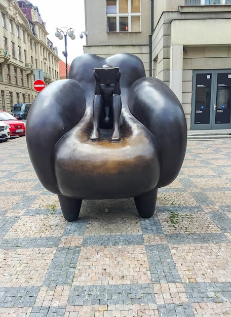 Reader in an armchair is a bronze sculpture by academic sculptor j rona prague