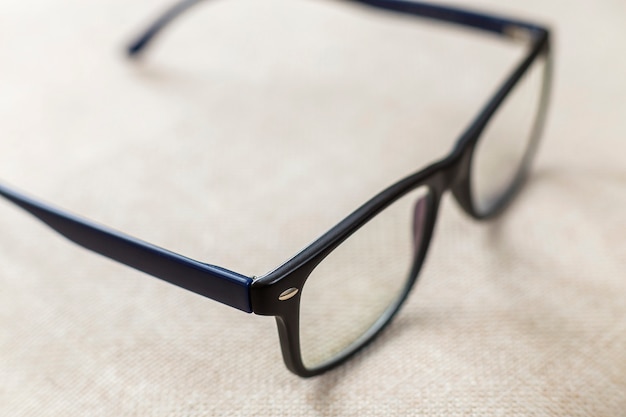 Reading spectacles, fashionable eyeglasses isolated on blurred white copy space.