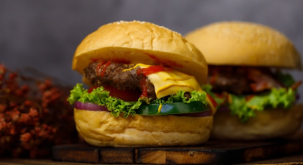 Ready to eat homemade pork hamburger with copy space in dark background.