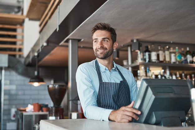 Ready to make a success of the day Shot of a young entrepreneur working in a cafe