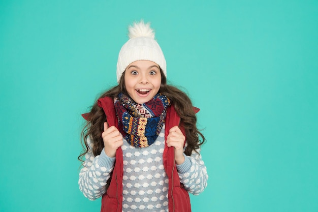 Ready for new year vacation. copy space. no hypothermia. surprised girl wearing layers of clothing. warm clothes at wintertime season. cold weather forecast. kid fashion and shopping. xmas time.