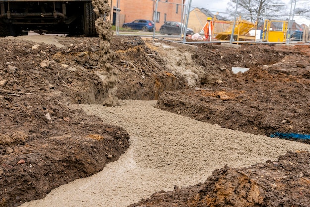 Readymix semidry concrete delivered on construction site and discharged from the mixing truck