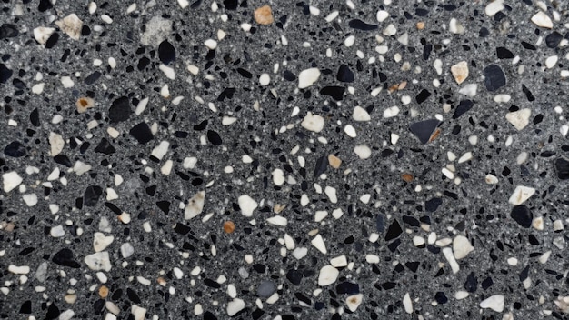 real black terrazzo marble pattern tile for interior flooring material grey terrazzo chips on black background matt rock flooring surface black background with grey chips